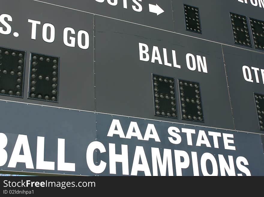 An American football scoreboard with State Champions logo. An American football scoreboard with State Champions logo.