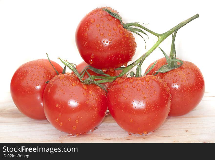 Bunch of wet tomato on a wooden shelf