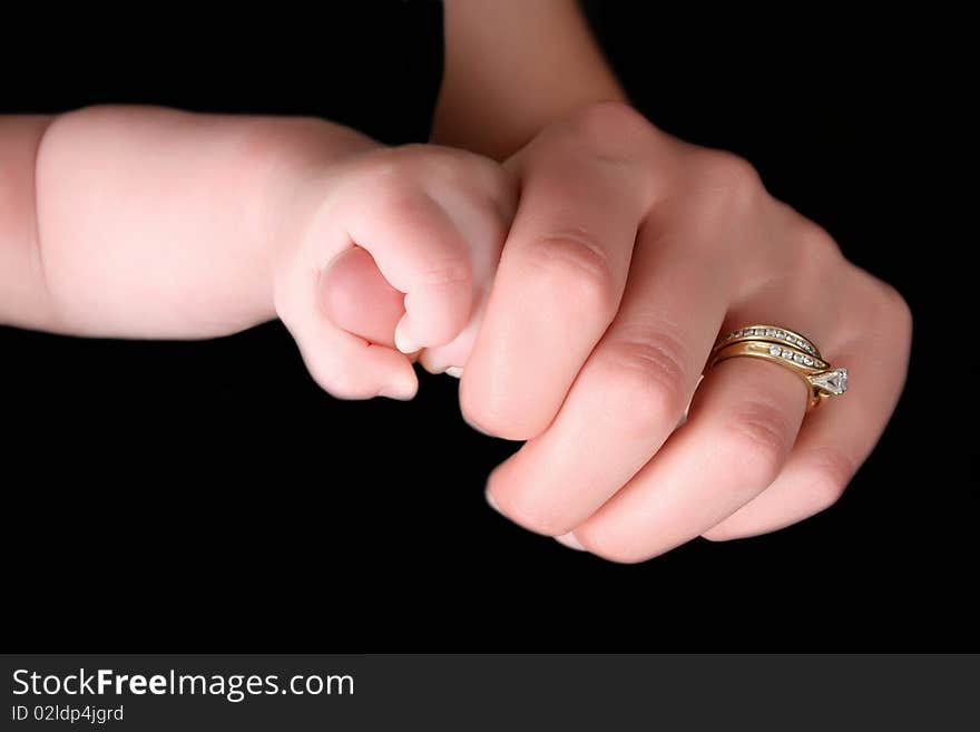 Caucasian mother and baby, baby holding mother's thumb