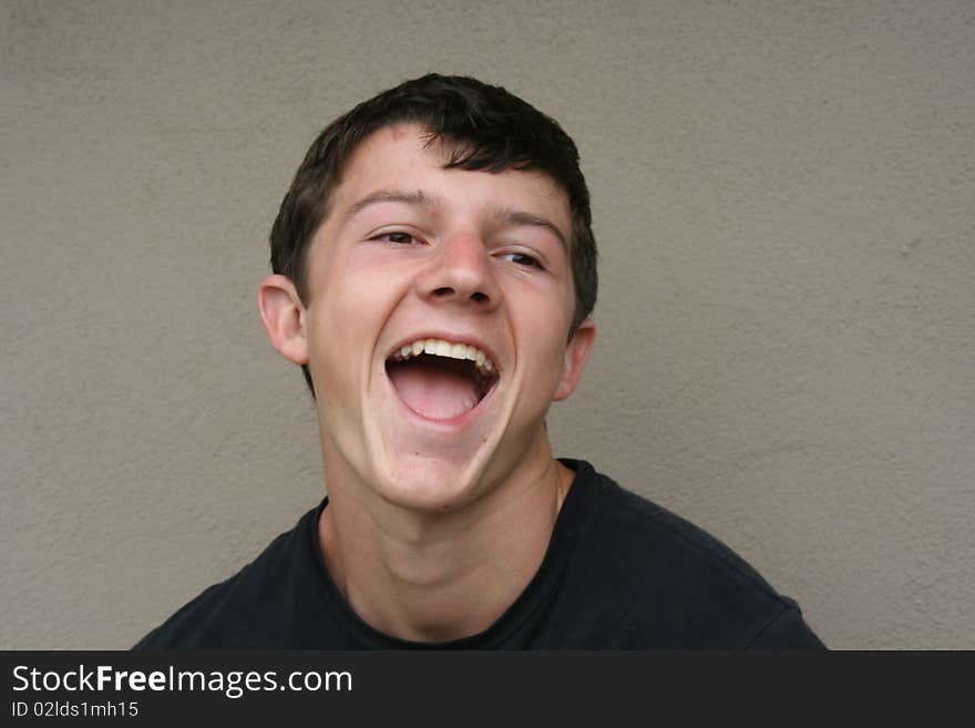 Head shot of a young man laughing. Head shot of a young man laughing.