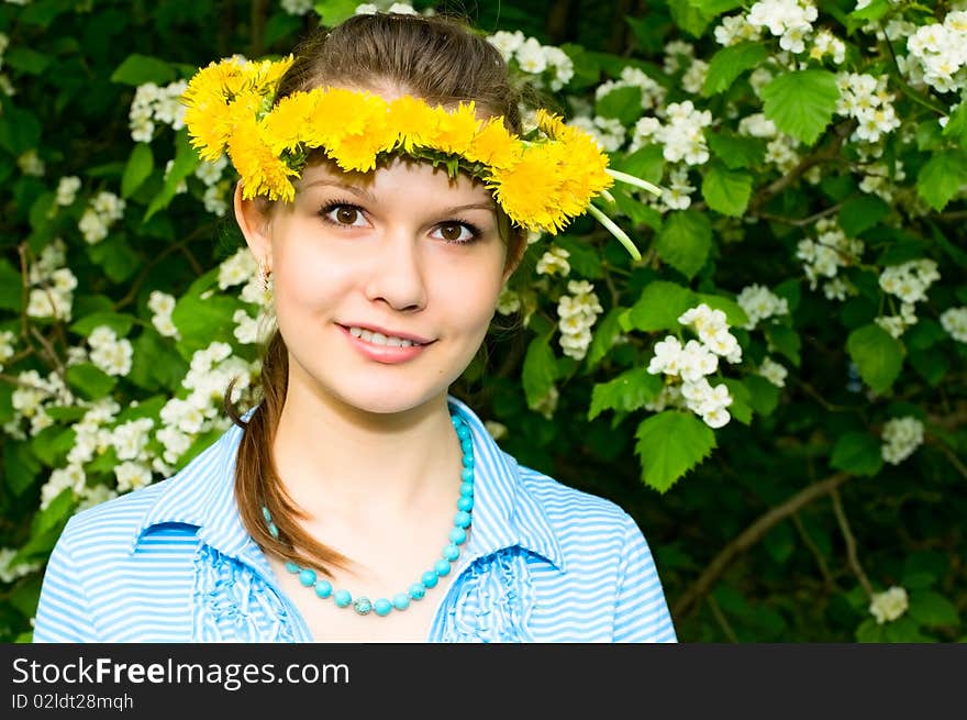 Portrait of young smiling woman in dandelion garland. Portrait of young smiling woman in dandelion garland