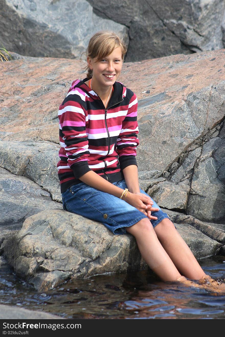 Beautiful Girl Sitting By The Water