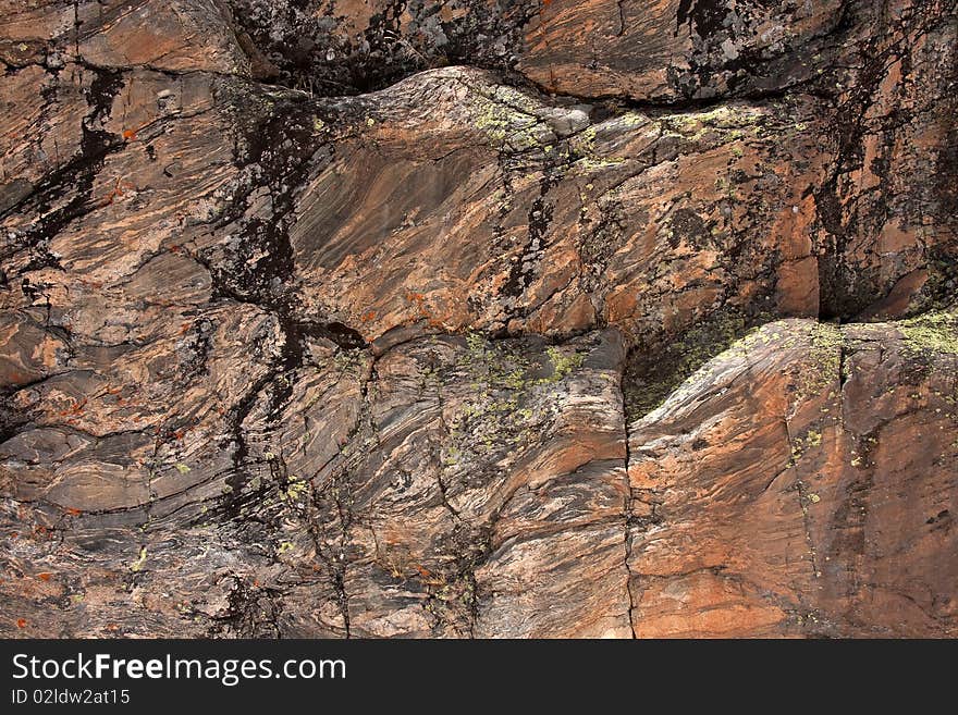 Texture of stone wall in mountains showing variation of color. Texture of stone wall in mountains showing variation of color