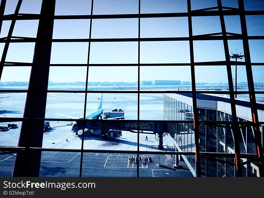 Parked aircraft on an airport through the gate window