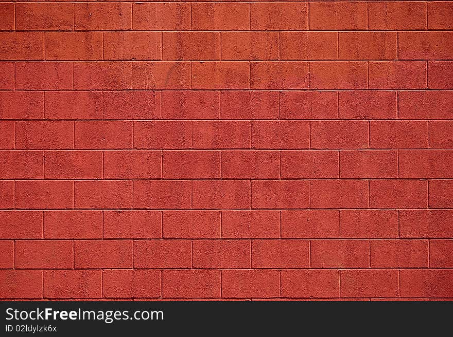 A view of a painted wall of cememt blocks in the deep color of red. A view of a painted wall of cememt blocks in the deep color of red.