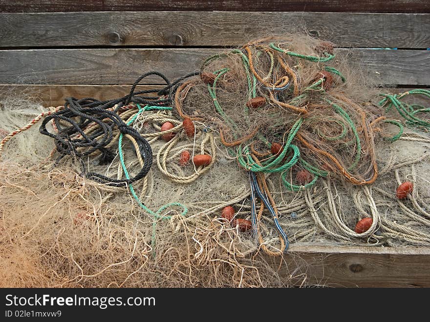 Heap of fishing nets with ropes and floats.