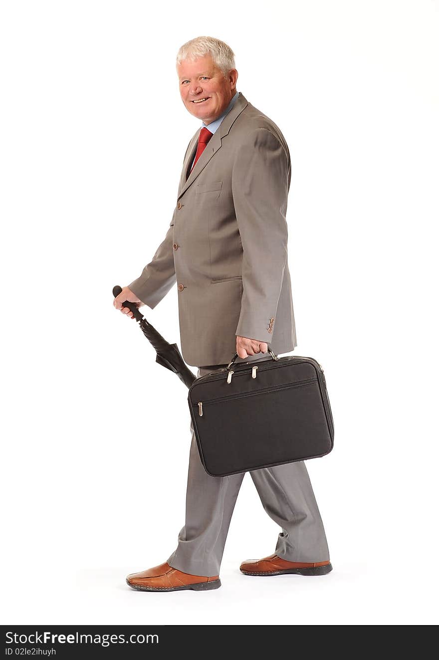 Successful mature business man on white background, with umbrella and briefcase. Successful mature business man on white background, with umbrella and briefcase