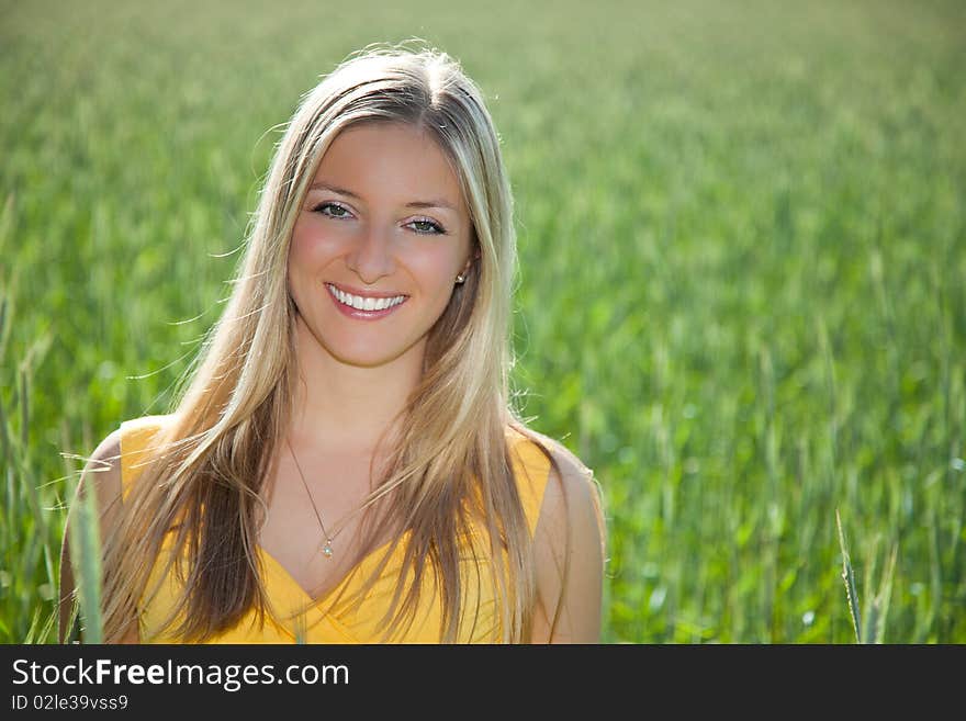 Smiling girl on field portrait in full sun. Smiling girl on field portrait in full sun