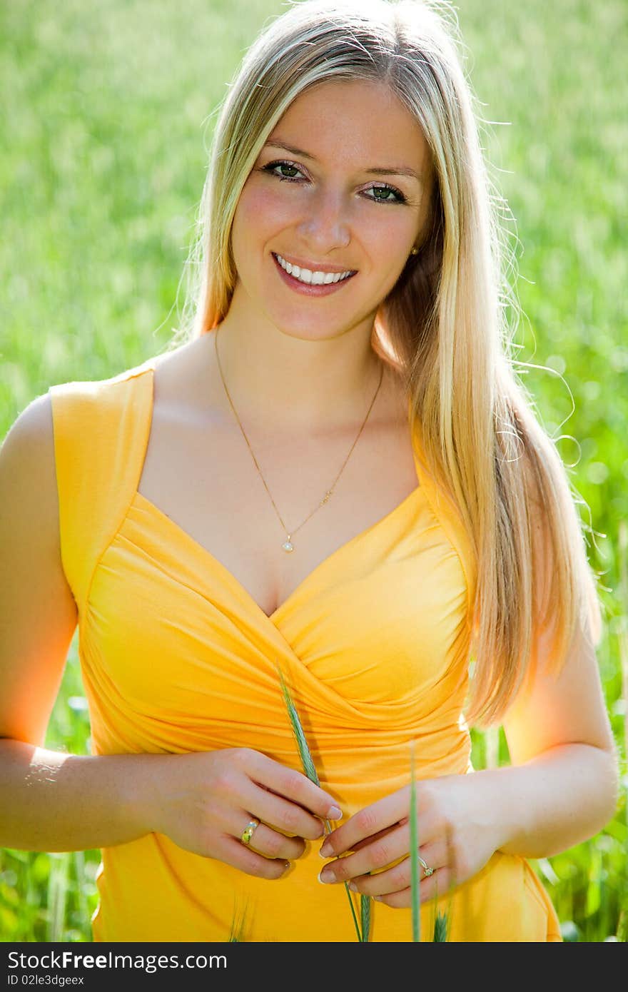 Smiling girl on field portrait in full sun. Smiling girl on field portrait in full sun