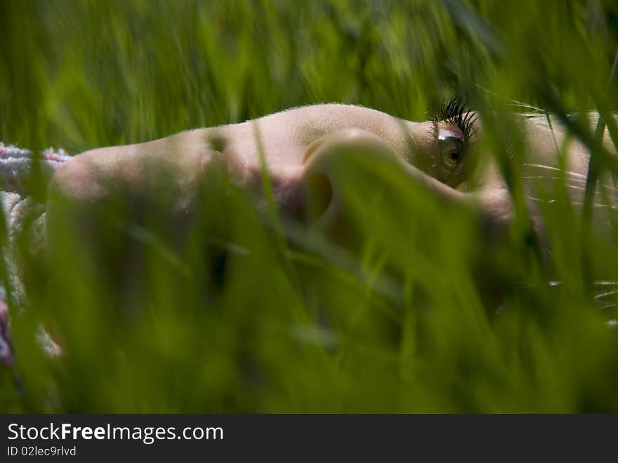 Portrait of the girl. In the spring on the nature in a grass. Portrait of the girl. In the spring on the nature in a grass.