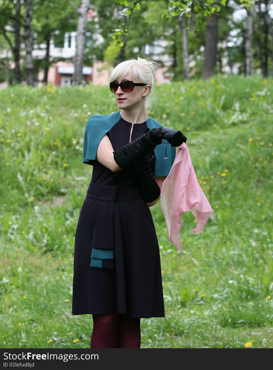 Portrait of the young girl  In solar glasses with a scarf in hands. Portrait of the young girl  In solar glasses with a scarf in hands