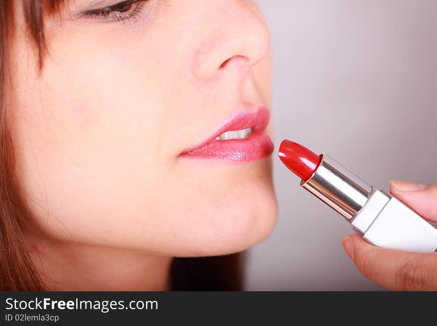 Lipstick being applied by a young woman. Lipstick being applied by a young woman.