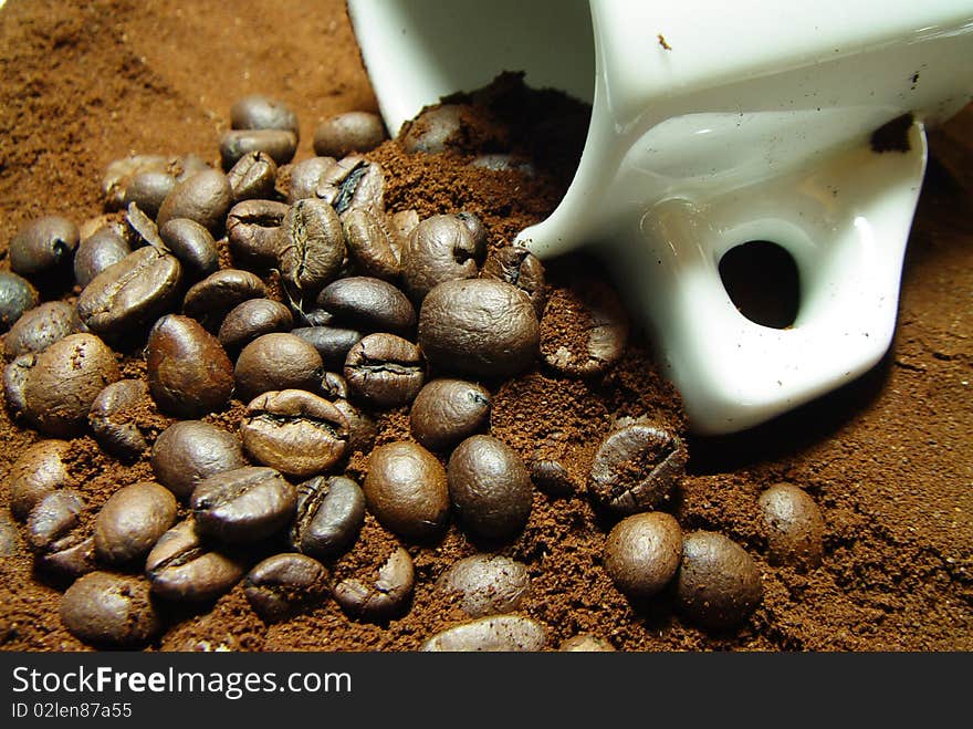 Roasted coffee beans with coffee and espresso cup