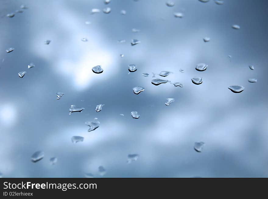 Attractive blue background; pane with drops. Attractive blue background; pane with drops