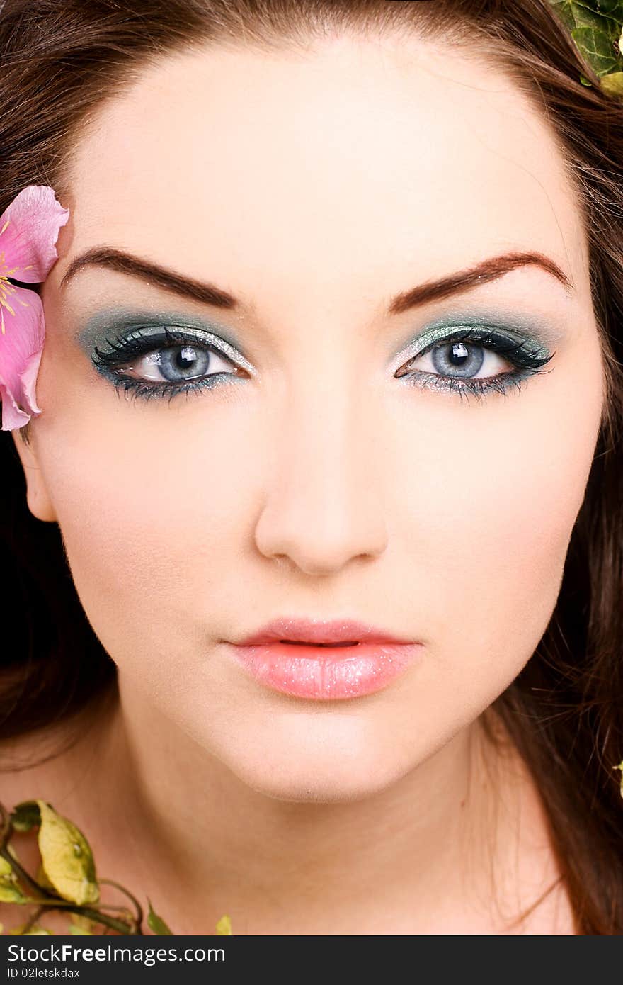 A beautiful young woman with flowers in her hair. A beautiful young woman with flowers in her hair.