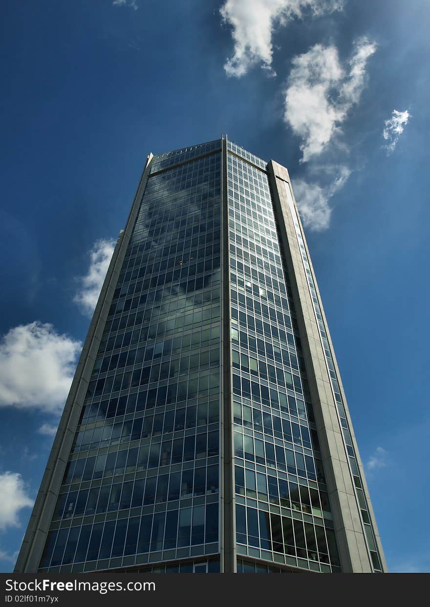 Down view on modern building with blue sky and clouds. Down view on modern building with blue sky and clouds