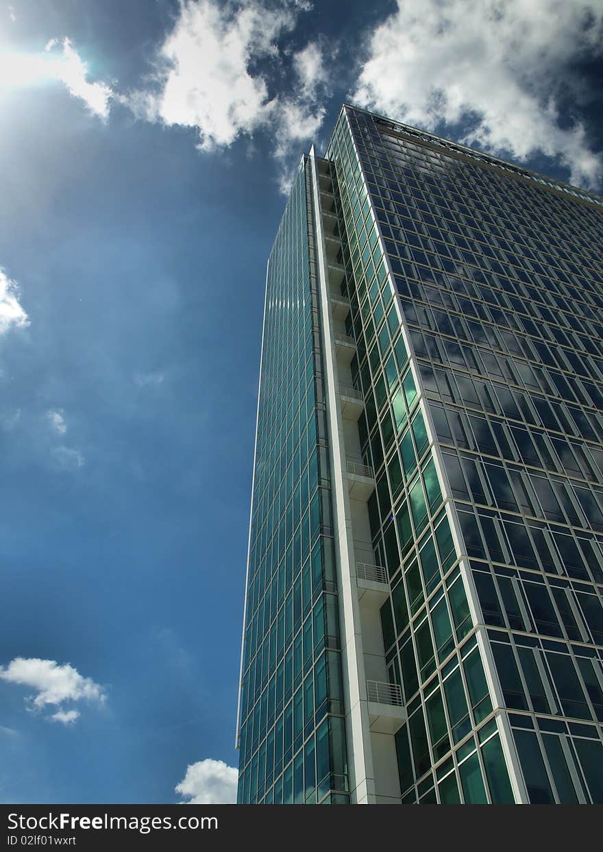 Down view on modern building with blue sky and clouds. Down view on modern building with blue sky and clouds