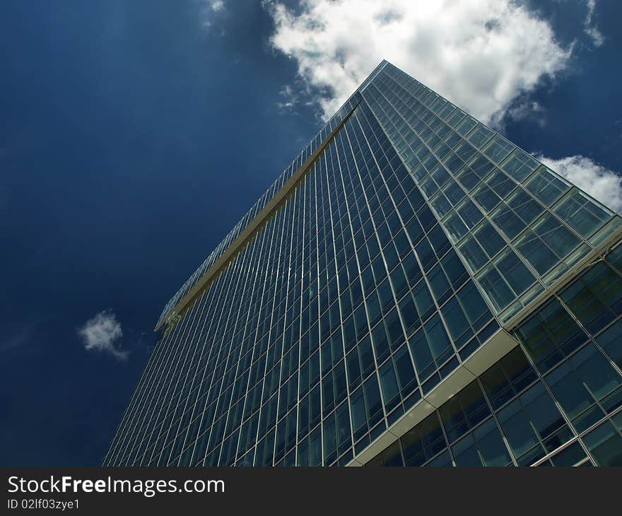 Down view on modern building with blue sky and clouds. Down view on modern building with blue sky and clouds