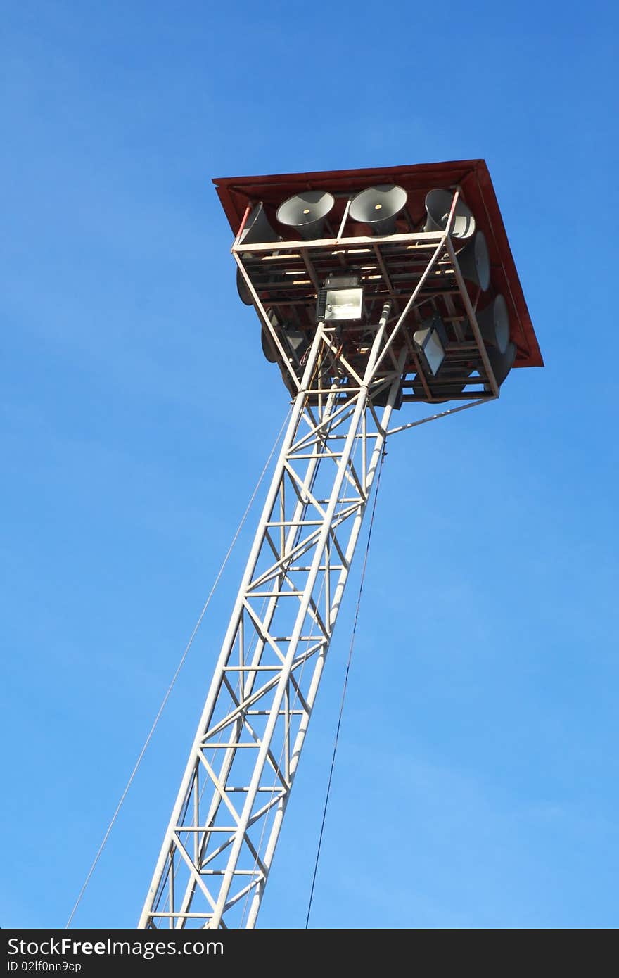 Lots of white loudspeakers on a tall station. Lots of white loudspeakers on a tall station