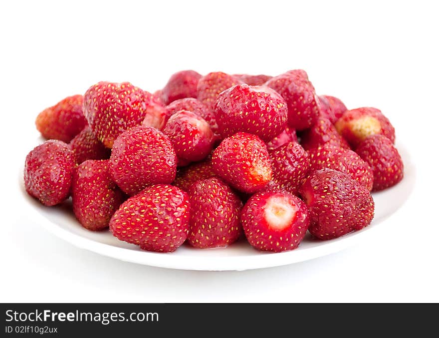 Ripe strawberry in a plate on a white background