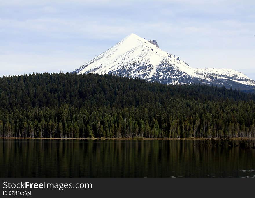 The snow-capped peak of Mount McLoughlin rises above the pine forest that surrounds the popular Lake of the Woods in southern Oregon. The snow-capped peak of Mount McLoughlin rises above the pine forest that surrounds the popular Lake of the Woods in southern Oregon.