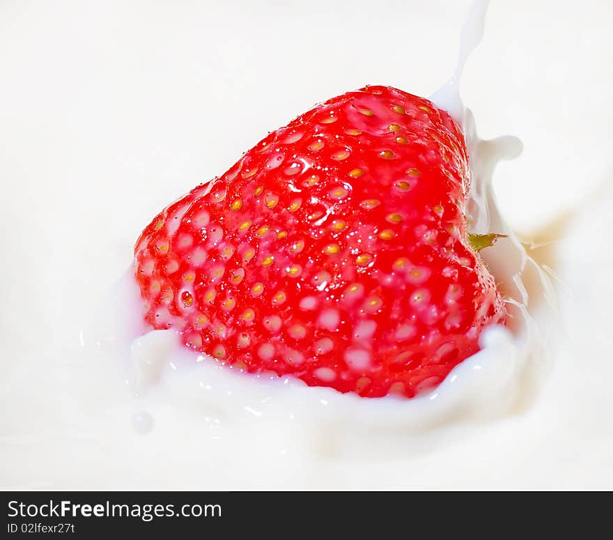 Fresh Strawberry Splashing Into Milk Or Yogurt