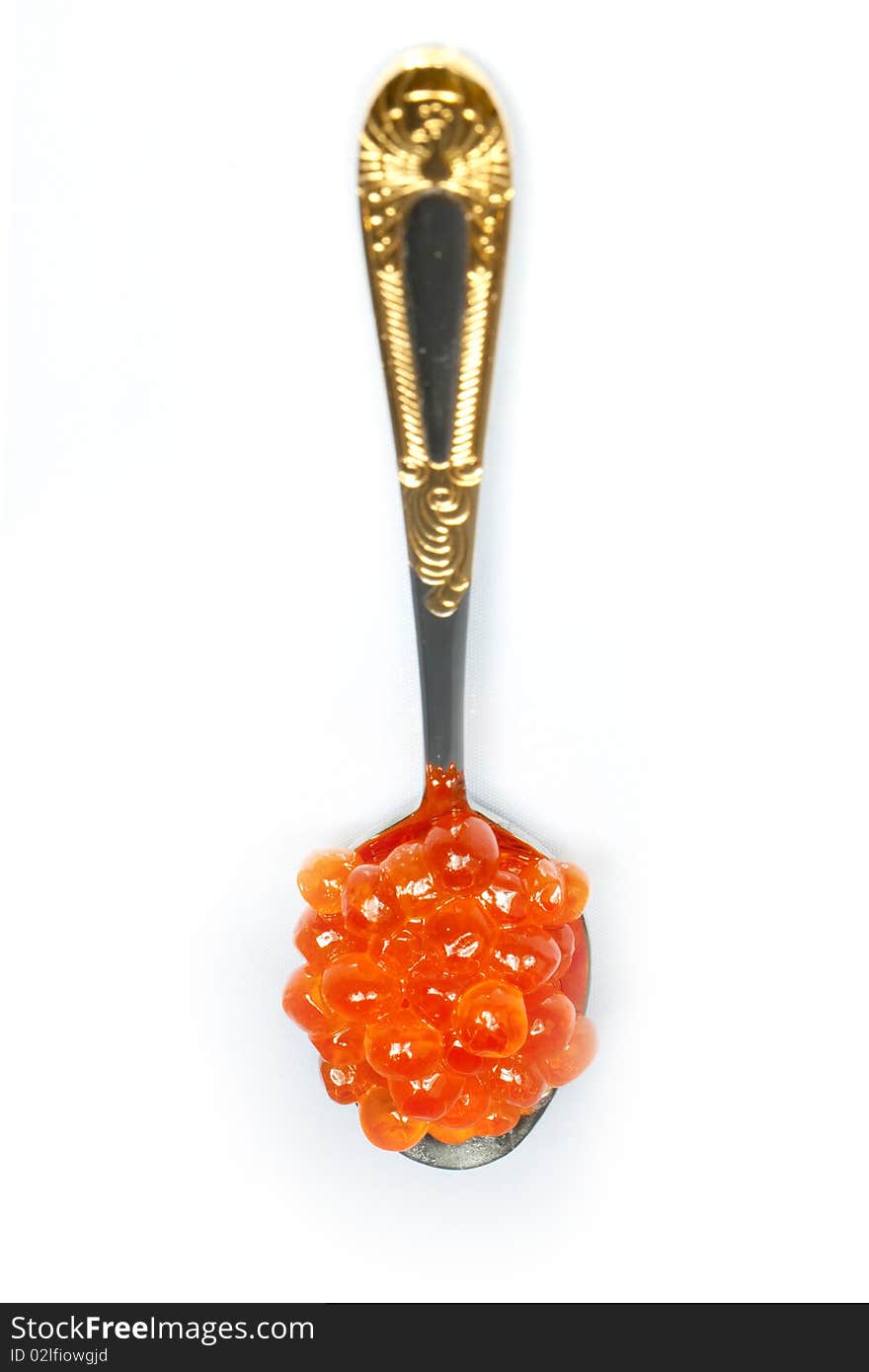 Teaspoon of red caviar on a white background