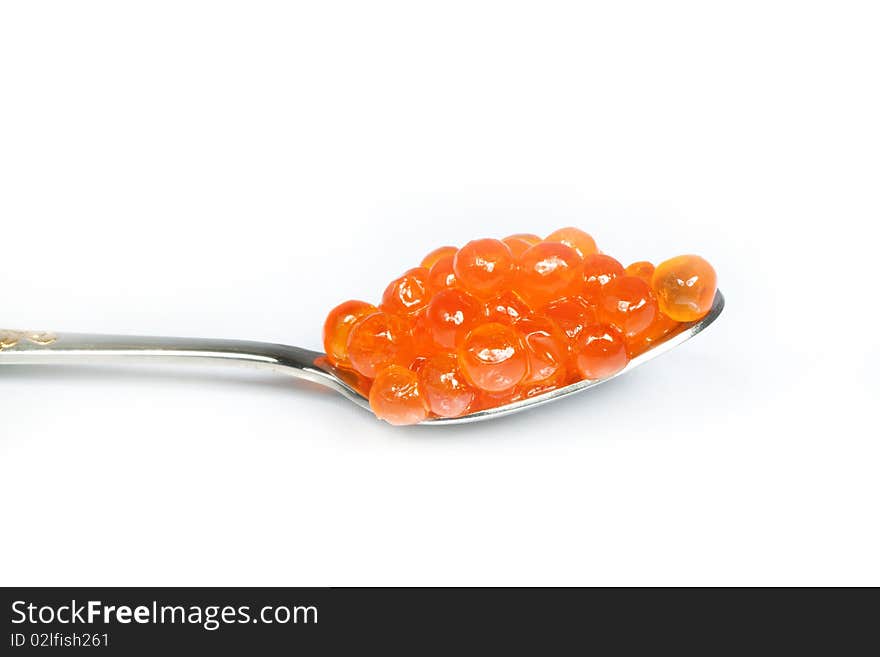 Teaspoon red caviar over white background