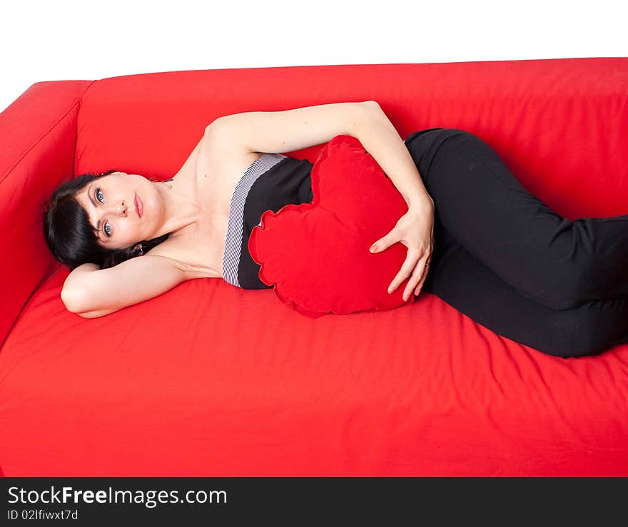 Woman looking at the camera laying on a sofa. Woman looking at the camera laying on a sofa