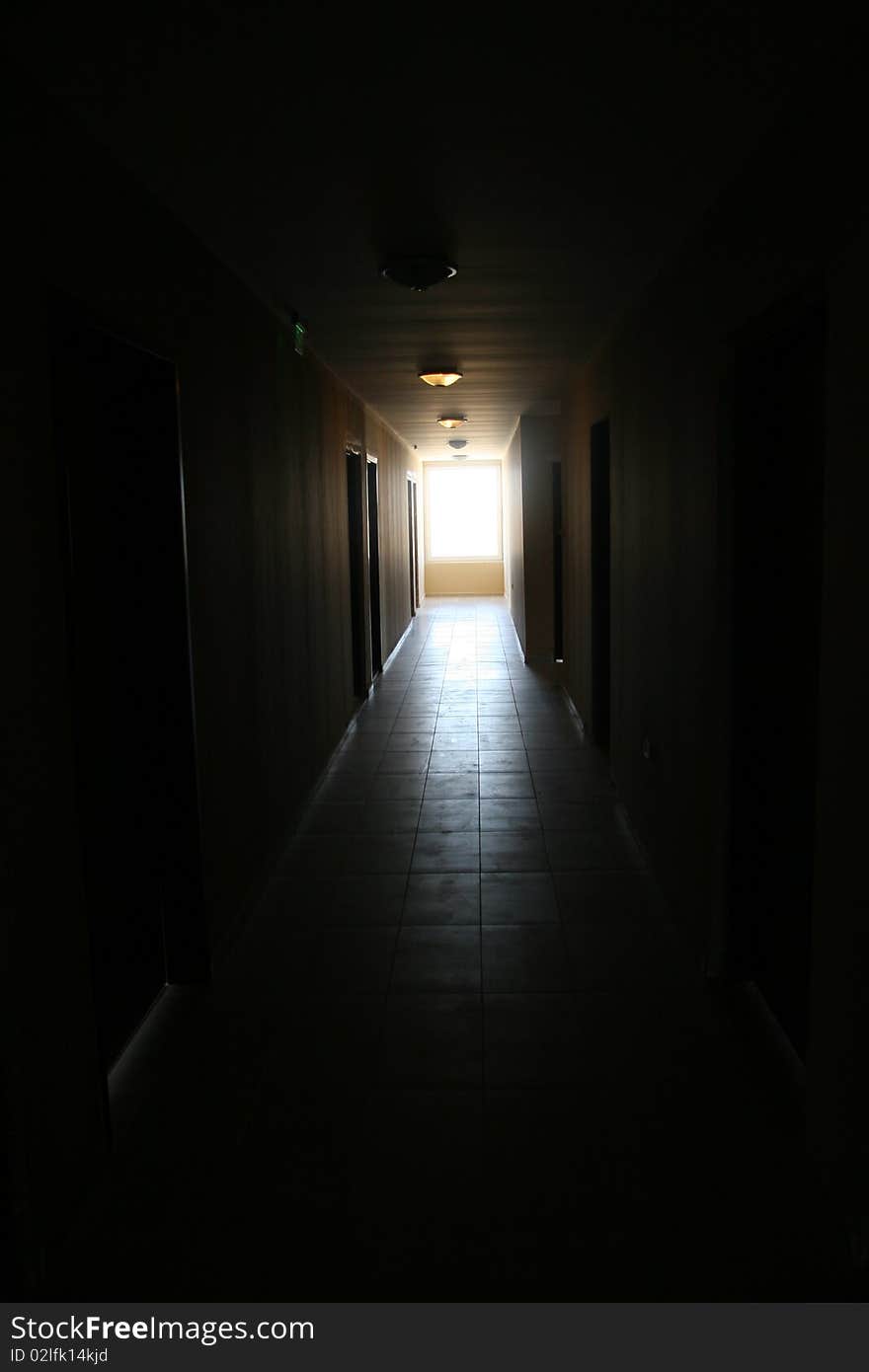 Corridor in a building, twilight, and in the end light from a window. Corridor in a building, twilight, and in the end light from a window