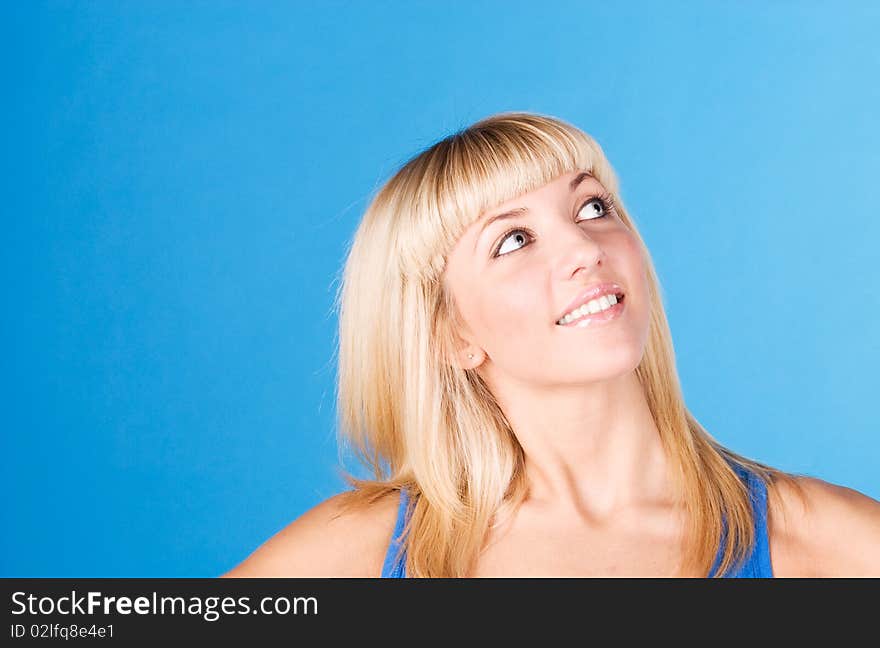 Portrait of happy young woman isolated on blue. Portrait of happy young woman isolated on blue