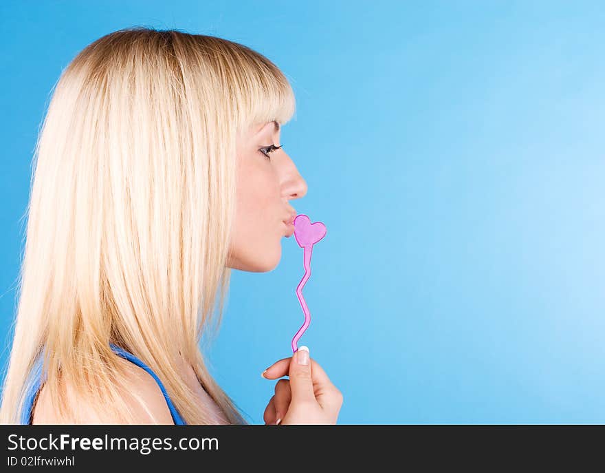 Portrait of sexy blond woman sucking her candy, love heart. Portrait of sexy blond woman sucking her candy, love heart