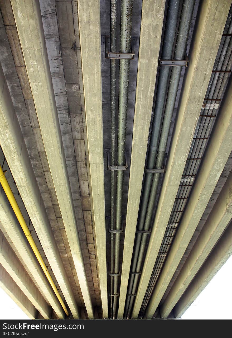 Photo of pipes passing under the city bridge