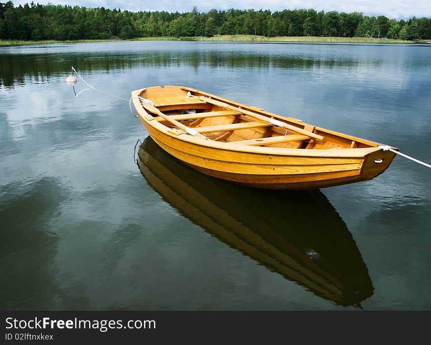 A typical swedish rowing boat, reflection in the water. A typical swedish rowing boat, reflection in the water.