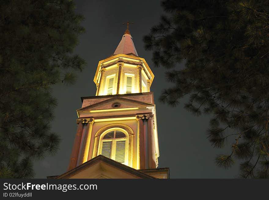 A historic cross of the church with black background. A historic cross of the church with black background.