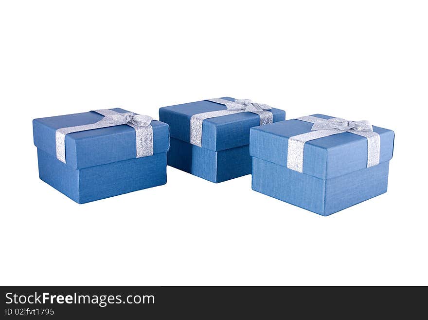 Three blue gift boxes with silver ribbons on it.