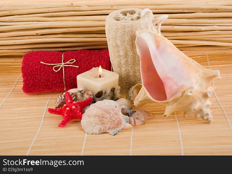 Bath accessories:towel and natural sponge on a bamboo background. Bath accessories:towel and natural sponge on a bamboo background.