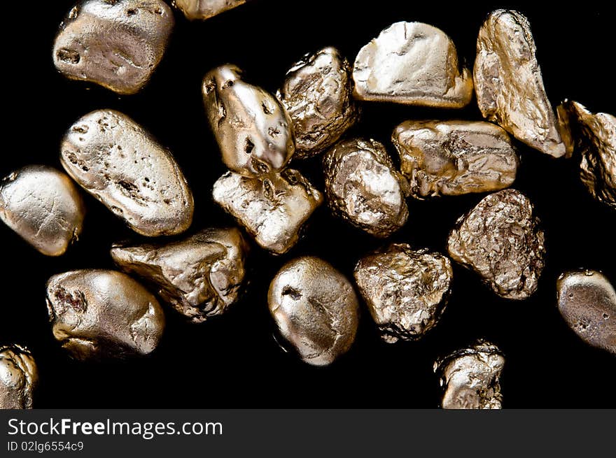 Gold nuggets on a black background. closeup.