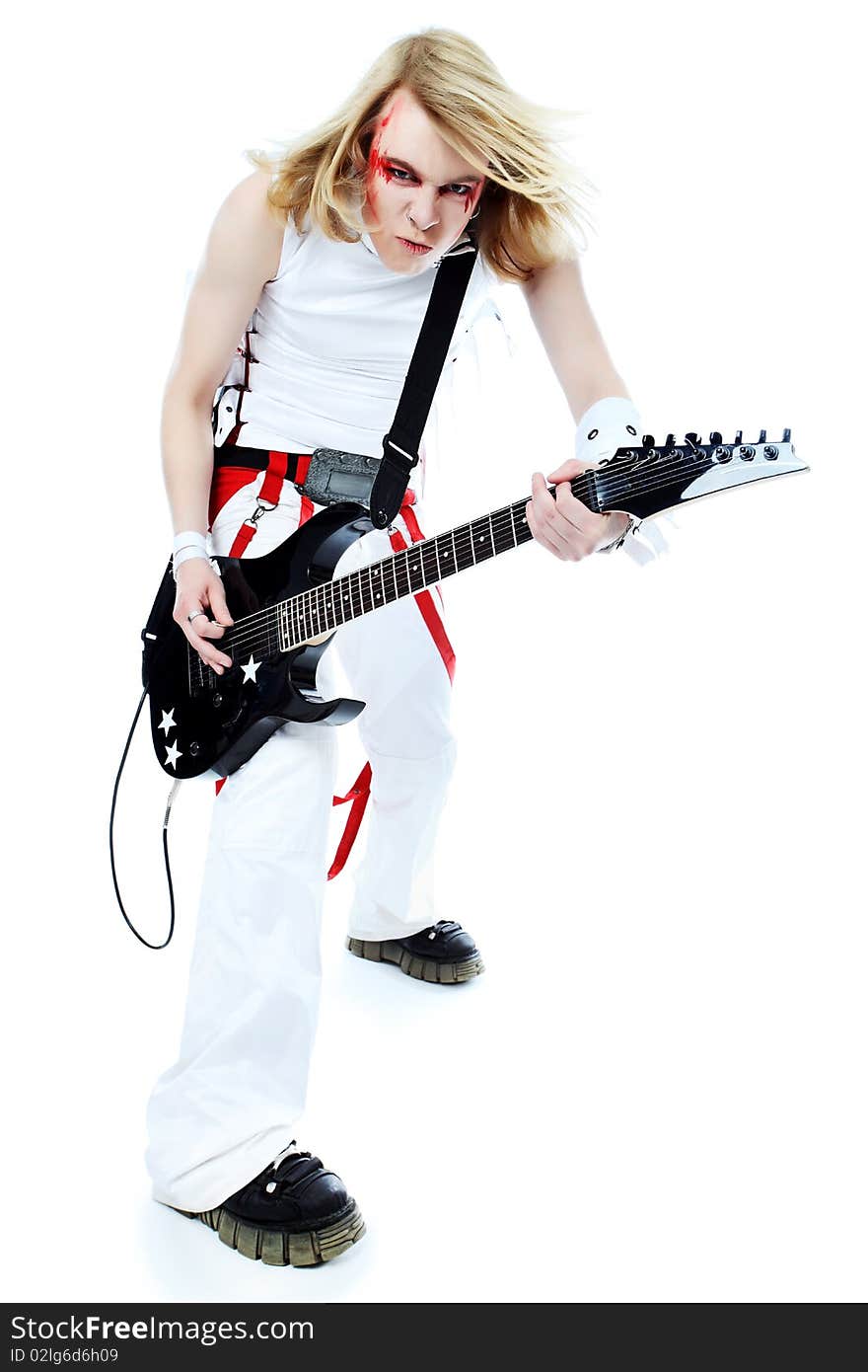 Rock musician is playing electrical guitar. Shot in a studio. Rock musician is playing electrical guitar. Shot in a studio.