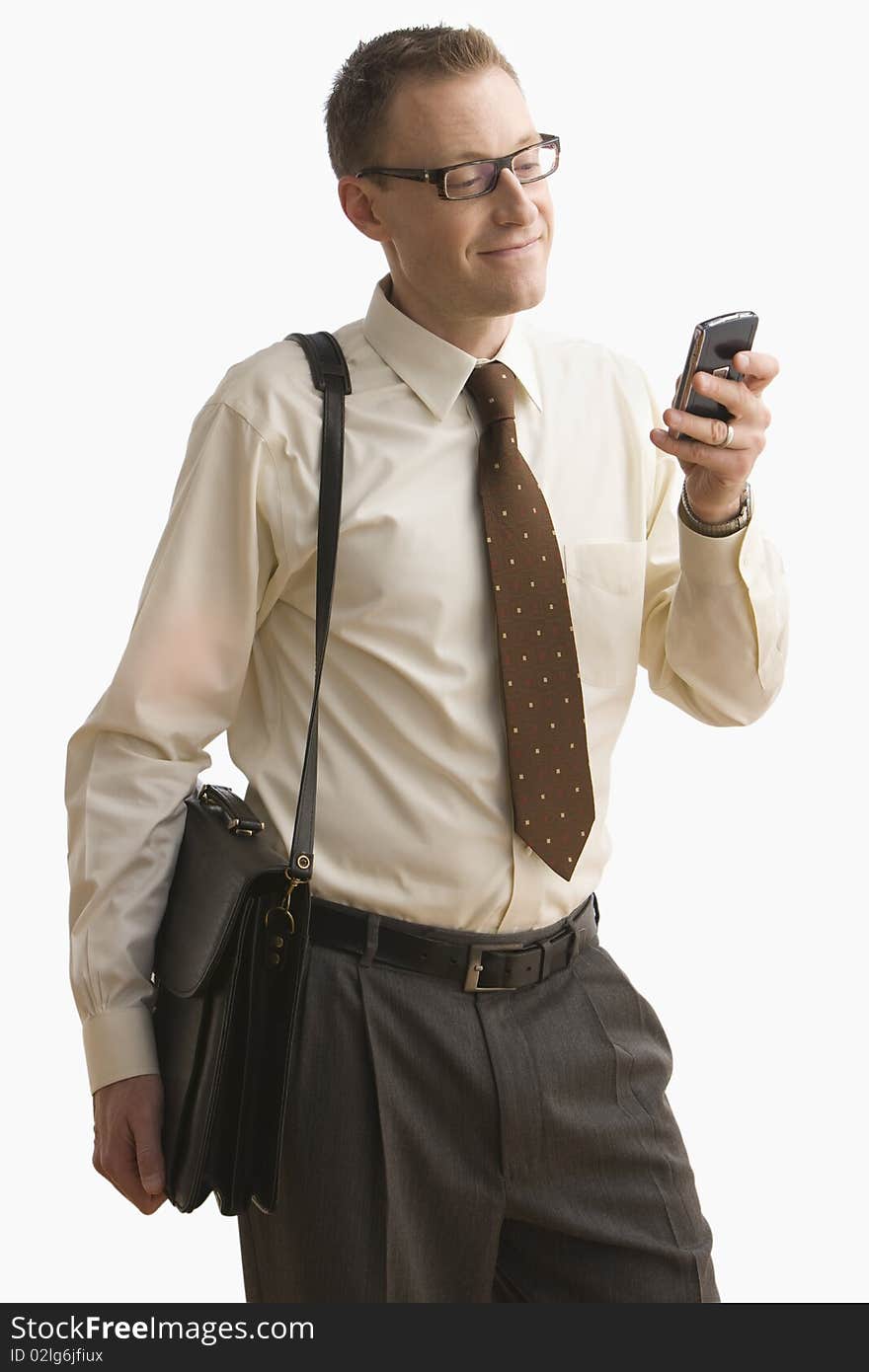 Businessman smiles as he writes a text message on his cellphone. Vertical shot. Isolated on white. Businessman smiles as he writes a text message on his cellphone. Vertical shot. Isolated on white.