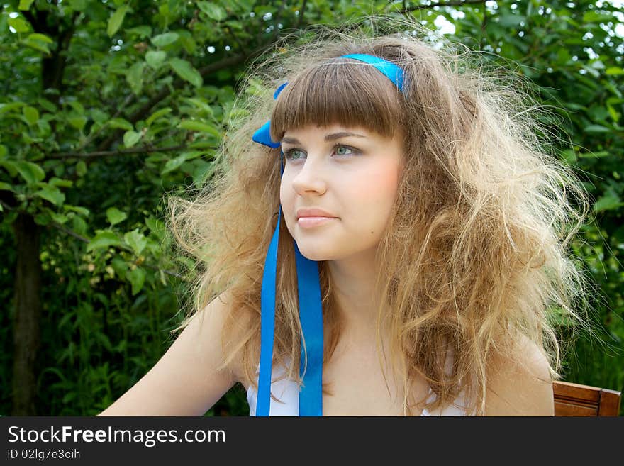 Beautiful girl with the crazy hair in the garden