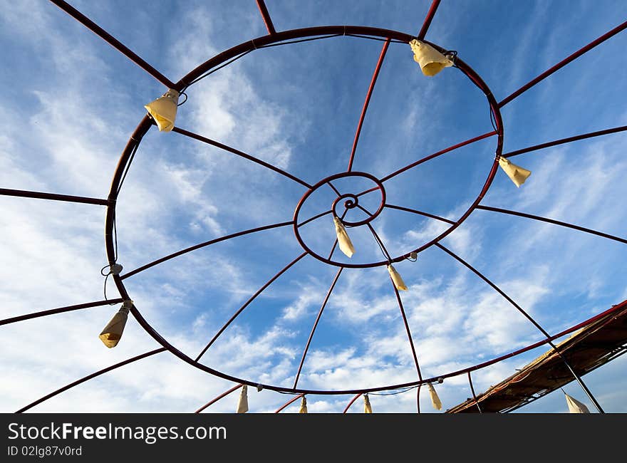 Spiral metallic frame against blue sky background. Spiral metallic frame against blue sky background