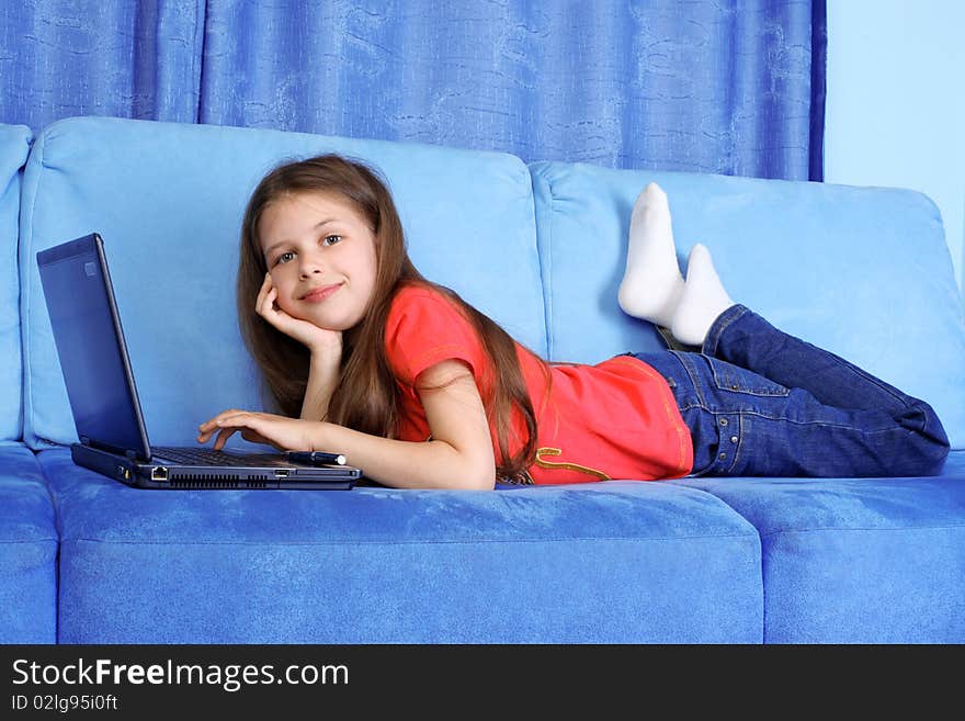 Girl with PC at home in sofa