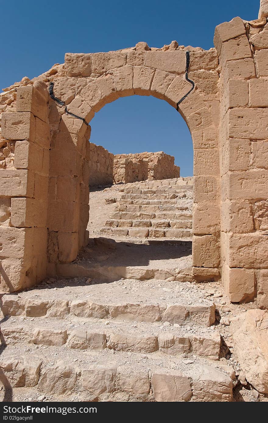 Ancient stone arch and staircase in bright summer day