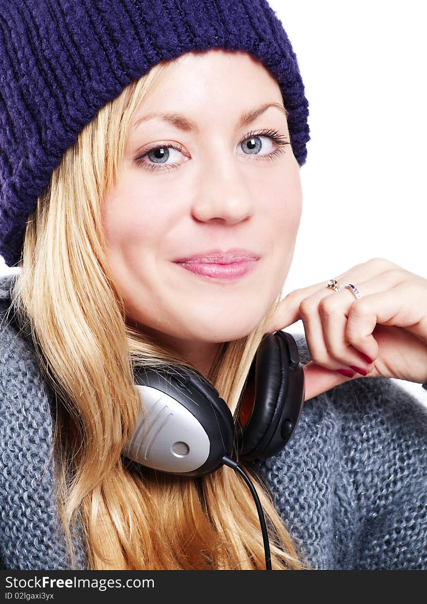 Closeup of smiling beautiful teenager with headphones listening music