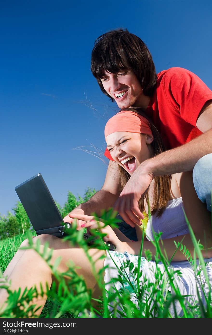 Boy And Long-haired Girl With Notebook On Grass