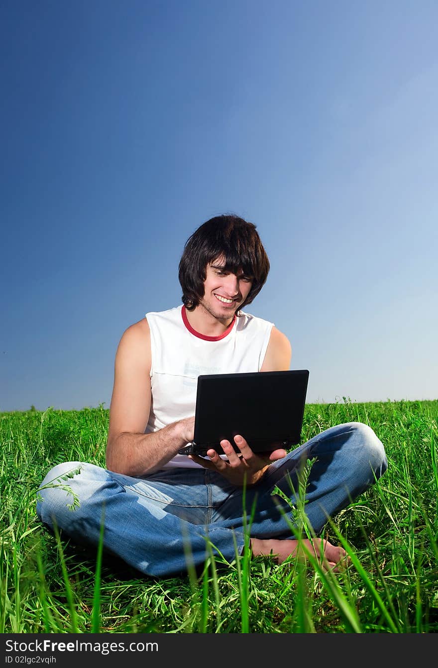 Boy With Notebook On Green Grass