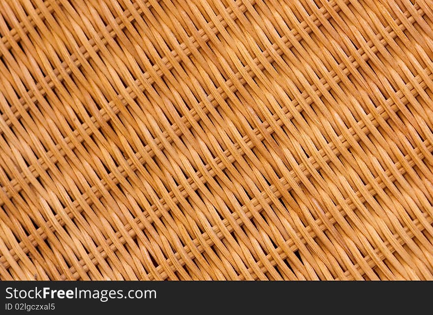 A close-up of a cane chair showing the texture and the pattern in a diagonal composition. A close-up of a cane chair showing the texture and the pattern in a diagonal composition