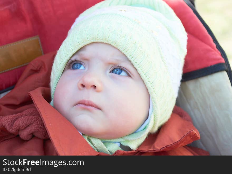 Portrait of the little girl sitting in a carriage. Portrait of the little girl sitting in a carriage