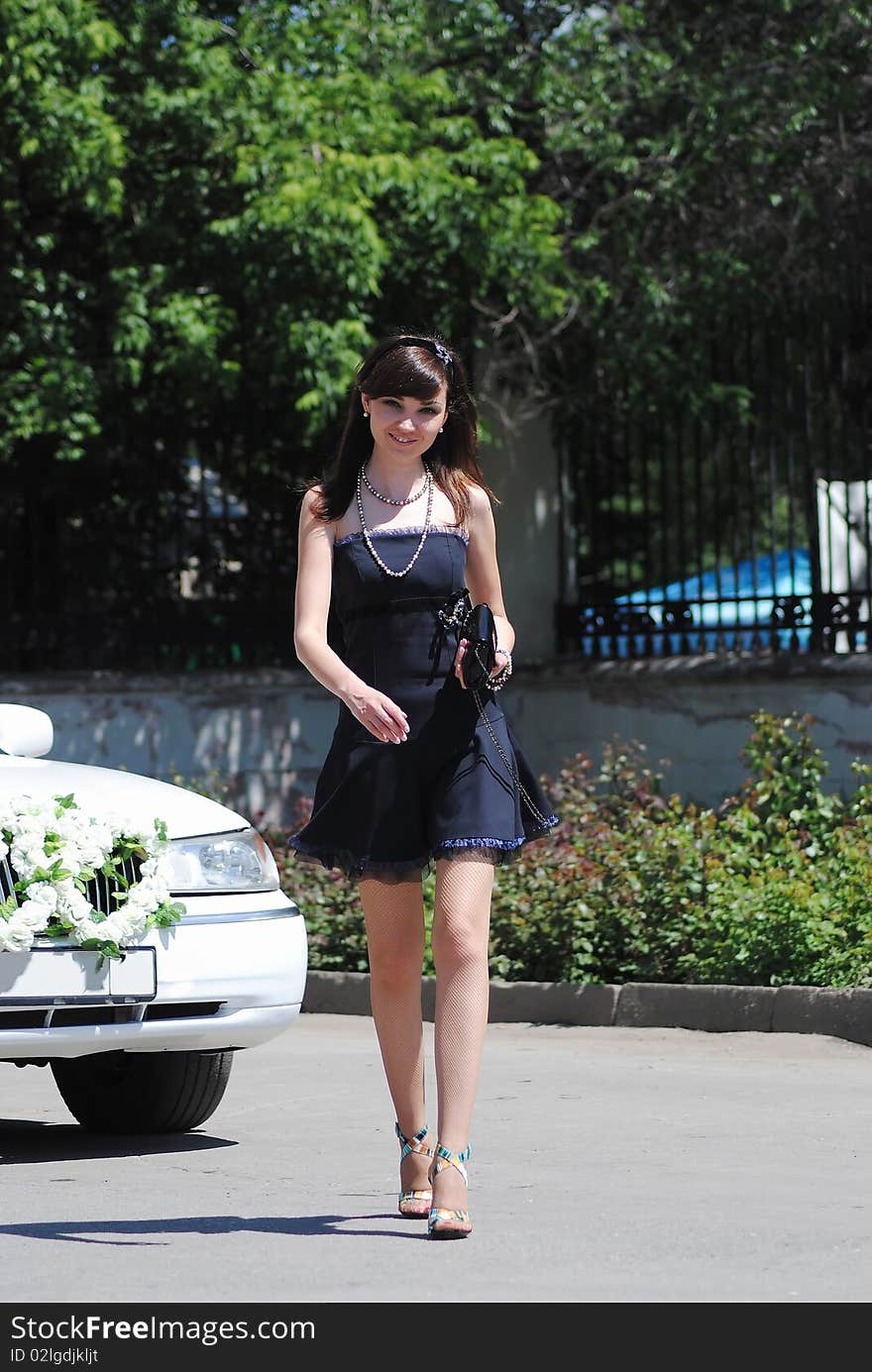 The young woman poses in the park in the summer